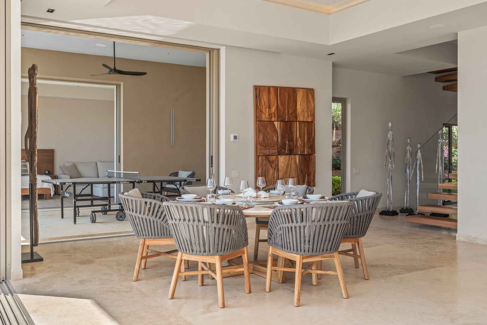 Step into an elegant dining space where natural wood tones and modern design invite you to gather for memorable meals with loved ones, seamlessly flowing into living areas perfect for relaxation.