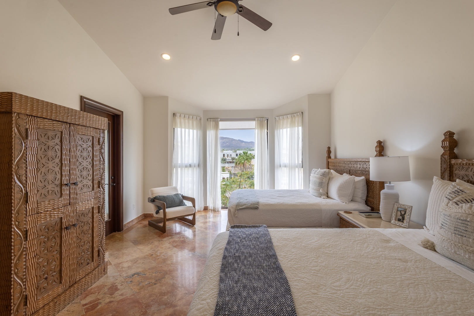 Drift off to sleep in this serene bedroom where handcrafted details meet modern comfort, overlooking peaceful mountain views.