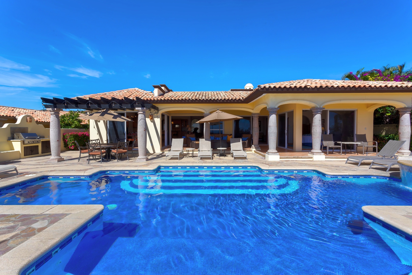 Dive into crystal-clear waters while soaking up endless sunshine at your private pool paradise, complete with loungers and shaded relaxation areas.