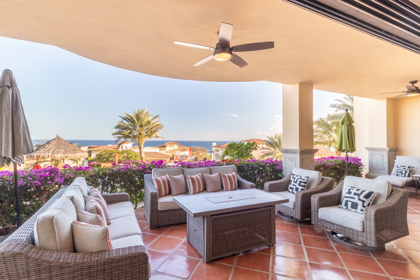 Your private terrace offers plush wicker seating, vibrant bougainvillea, and sweeping ocean views—perfect for morning coffee or sunset cocktails in absolute comfort.