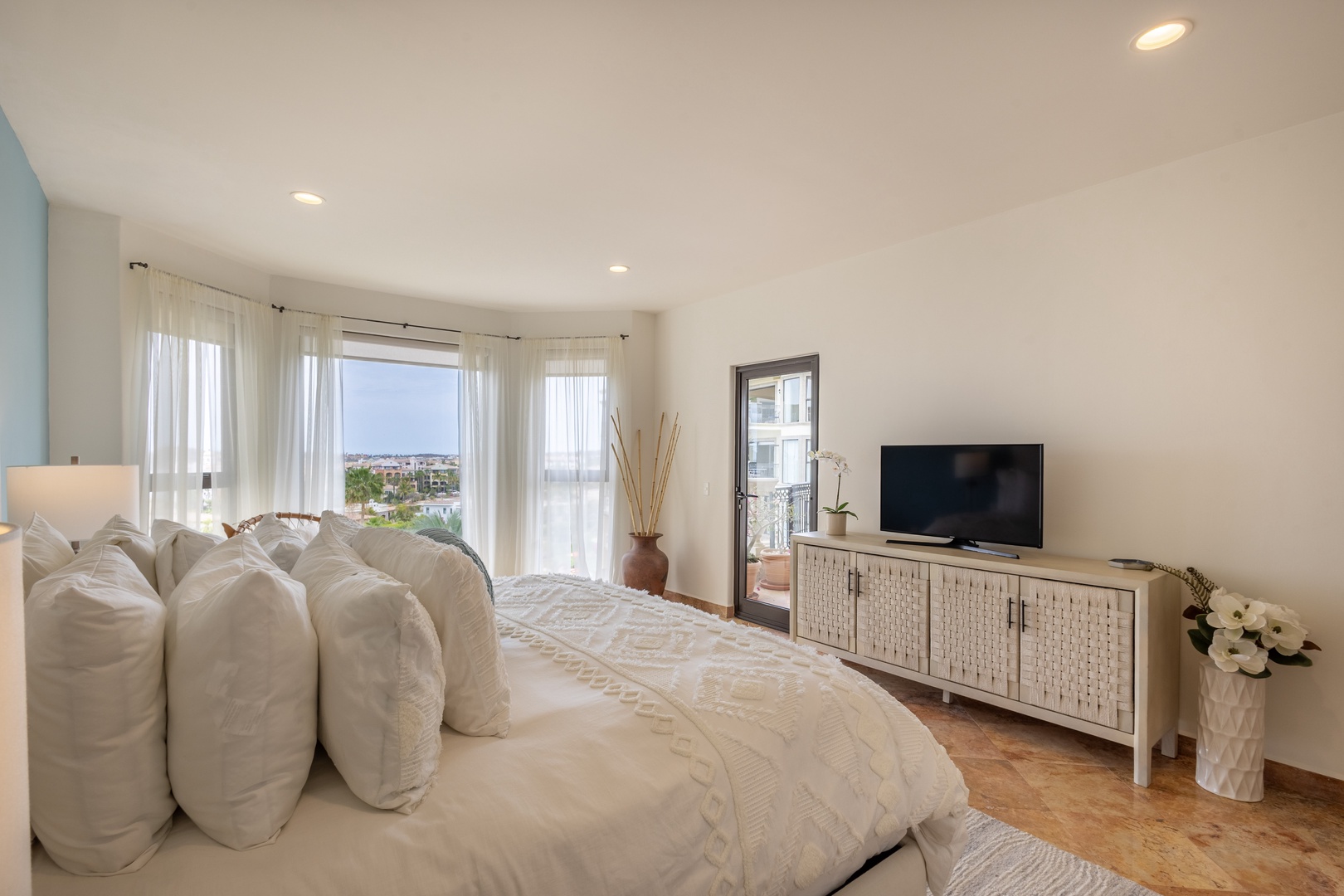 Sink into luxury bedding while enjoying stunning city views from your private retreat with modern entertainment and elegant touches.