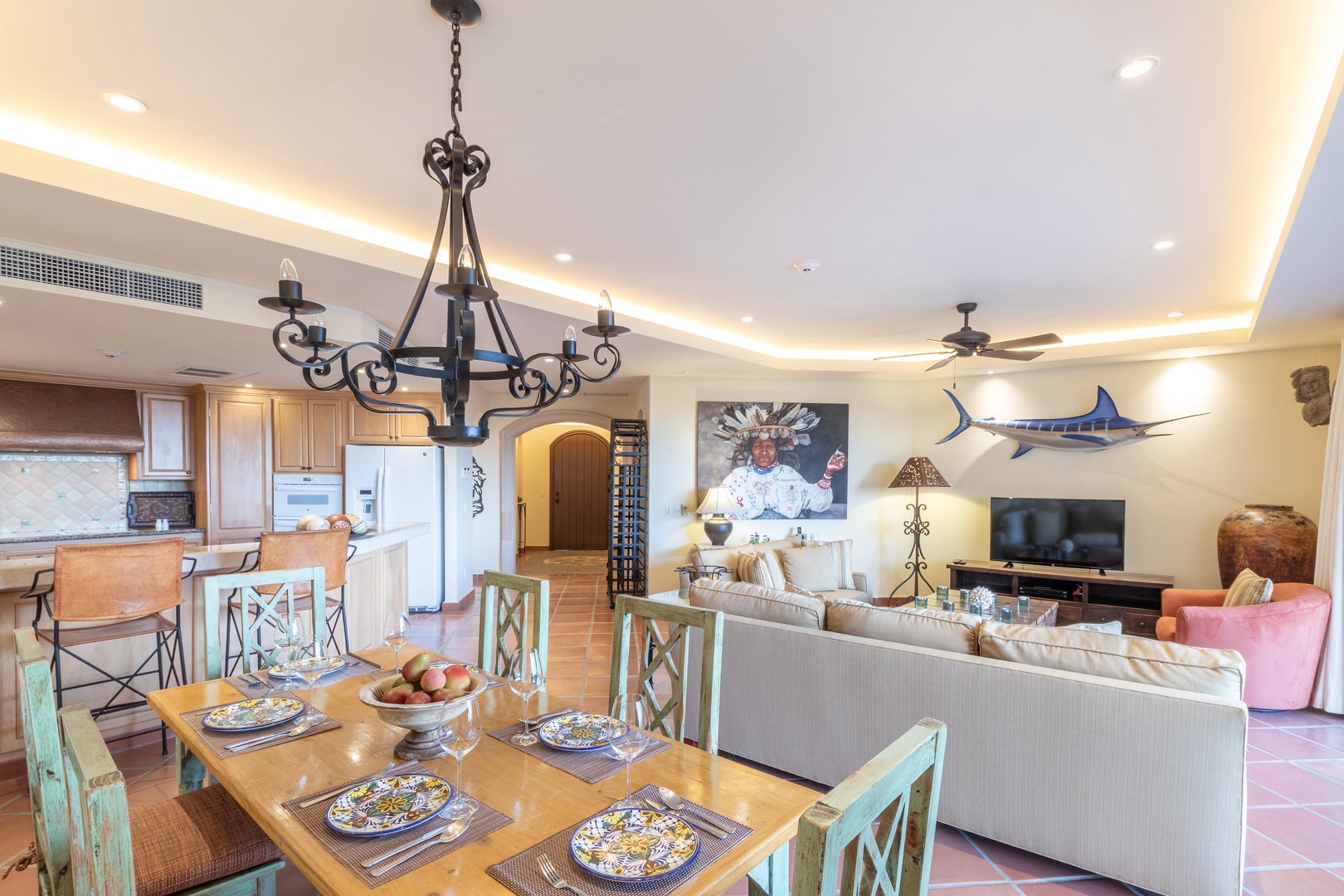 This open-concept space welcomes you with coastal charm: a handsome chandelier above your dining table, a fully-equipped kitchen, and a living room with stunning marlin art—perfect for memorable meals and family time.