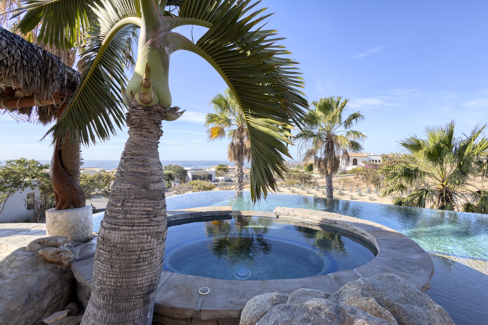 Soak in your private hot tub surrounded by swaying palm trees, then cool off in the infinity pool overlooking stunning desert vistas.