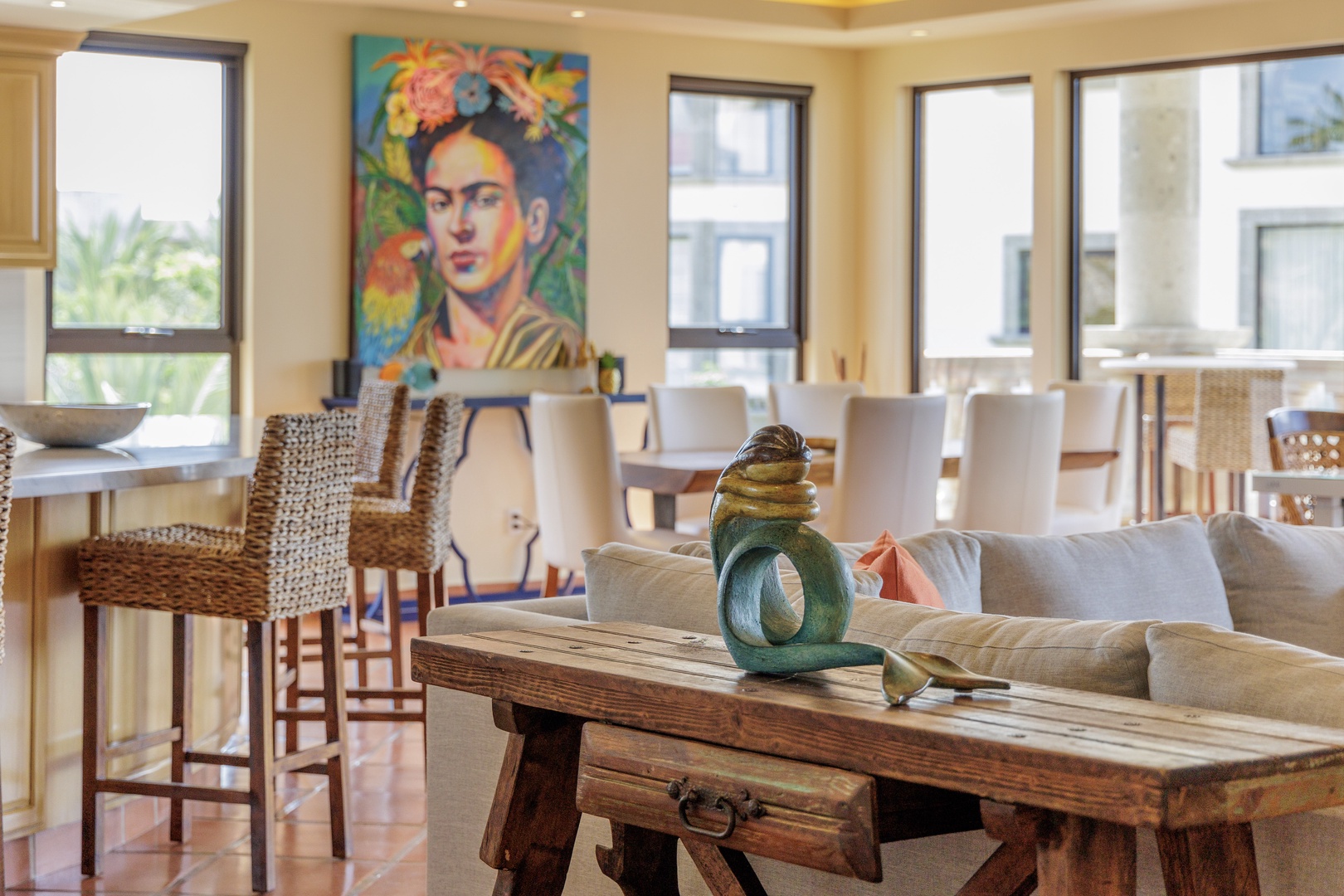 Sink into plush sofas in your open-concept living and dining space, where vibrant artwork and natural light create a welcoming atmosphere for memorable moments together.