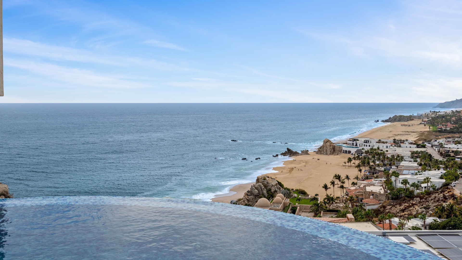 Spectacular coastal property overlooking pristine sandy beaches and rocky coastline with resort amenities nearby.