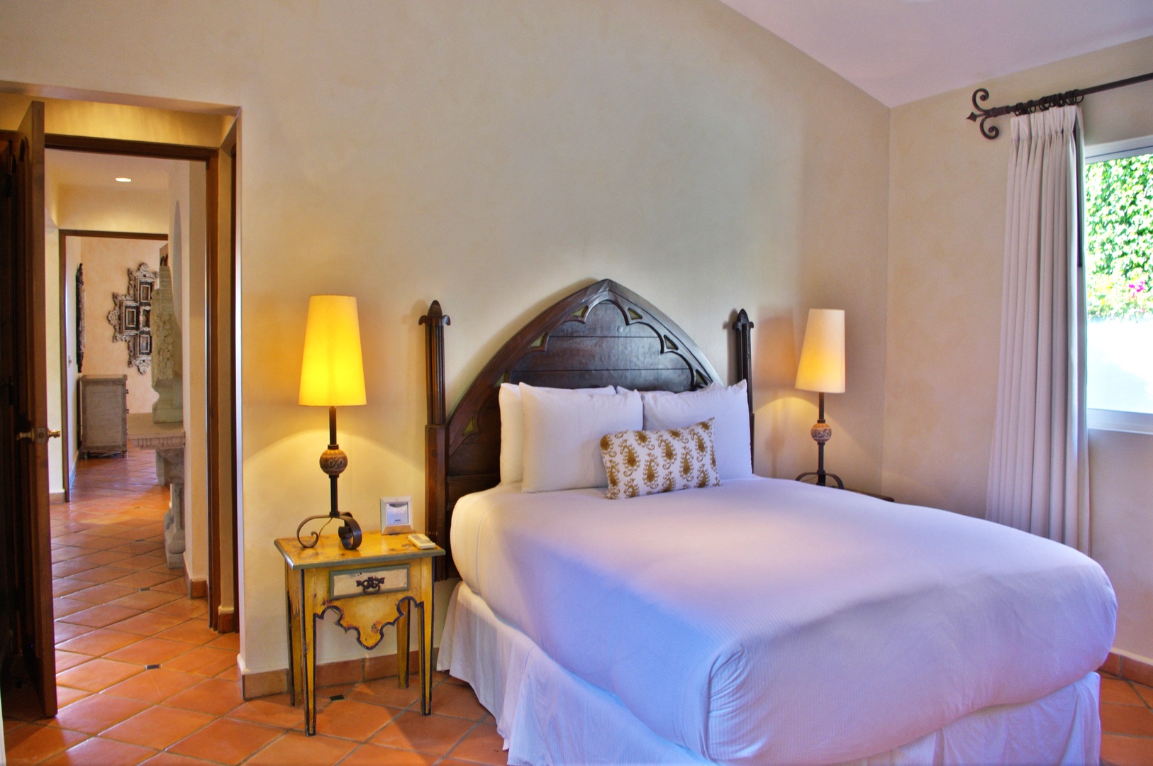 Step into your serene retreat with crisp linens, warm terracotta floors, and charming Spanish-inspired details that invite you to unwind in style.