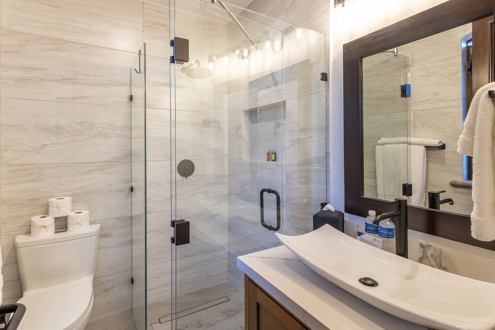 Your modern bathroom features a spacious walk-in shower, sleek vanity, and soft towels—everything you need to refresh after a day of adventure.