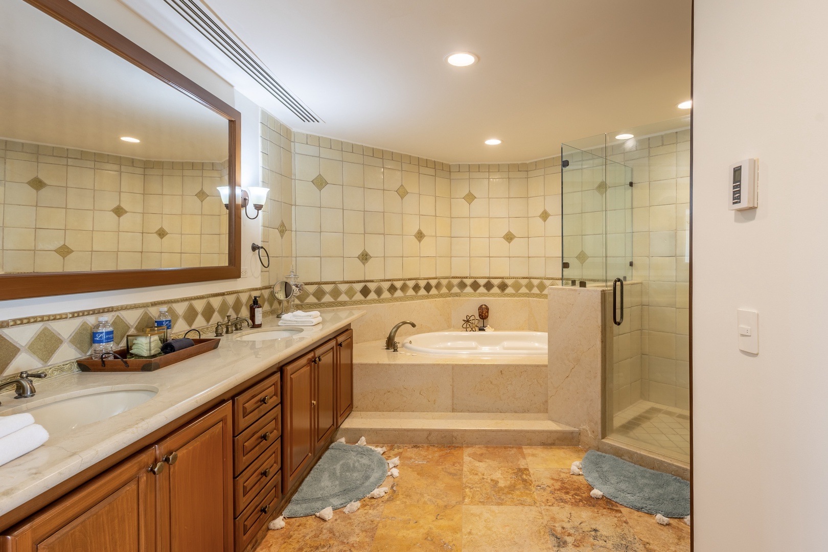Unwind in your luxurious master bathroom with a deep soaking tub and spacious glass shower after exploring all day.