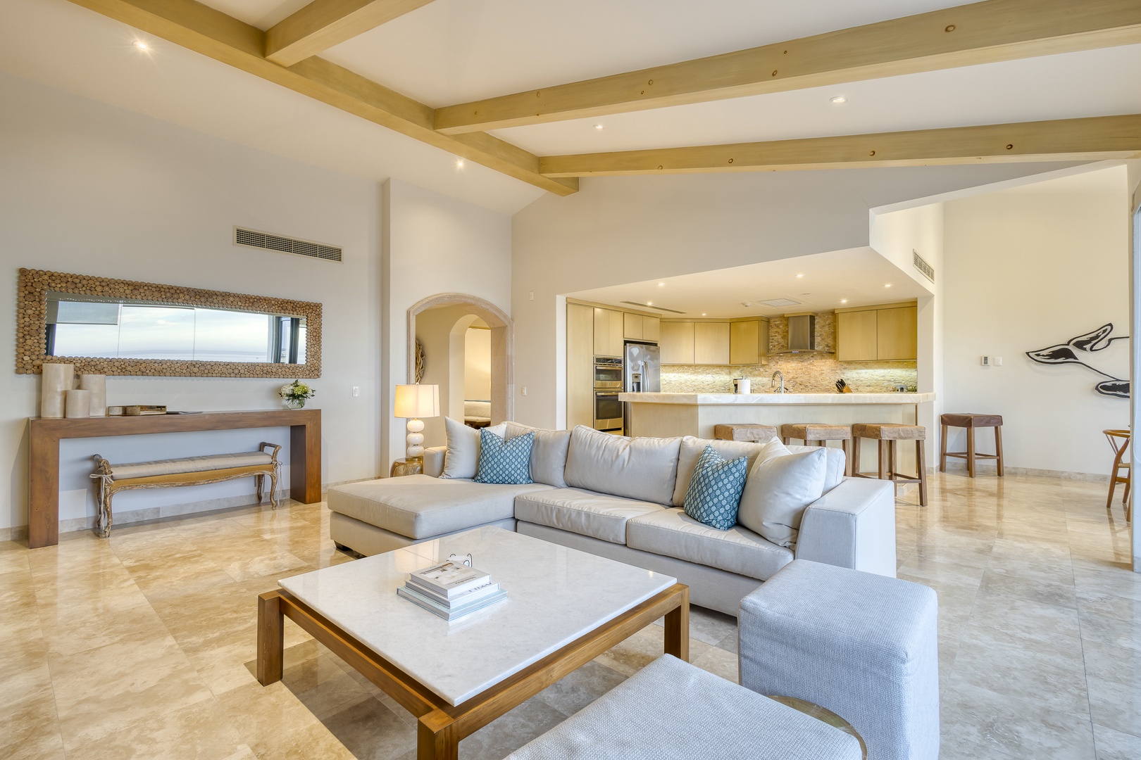 Relax in your bright, open-concept living space with soaring ceilings, warm wood beams, and seamless flow into a fully equipped modern kitchen—perfect for gathering with loved ones.
