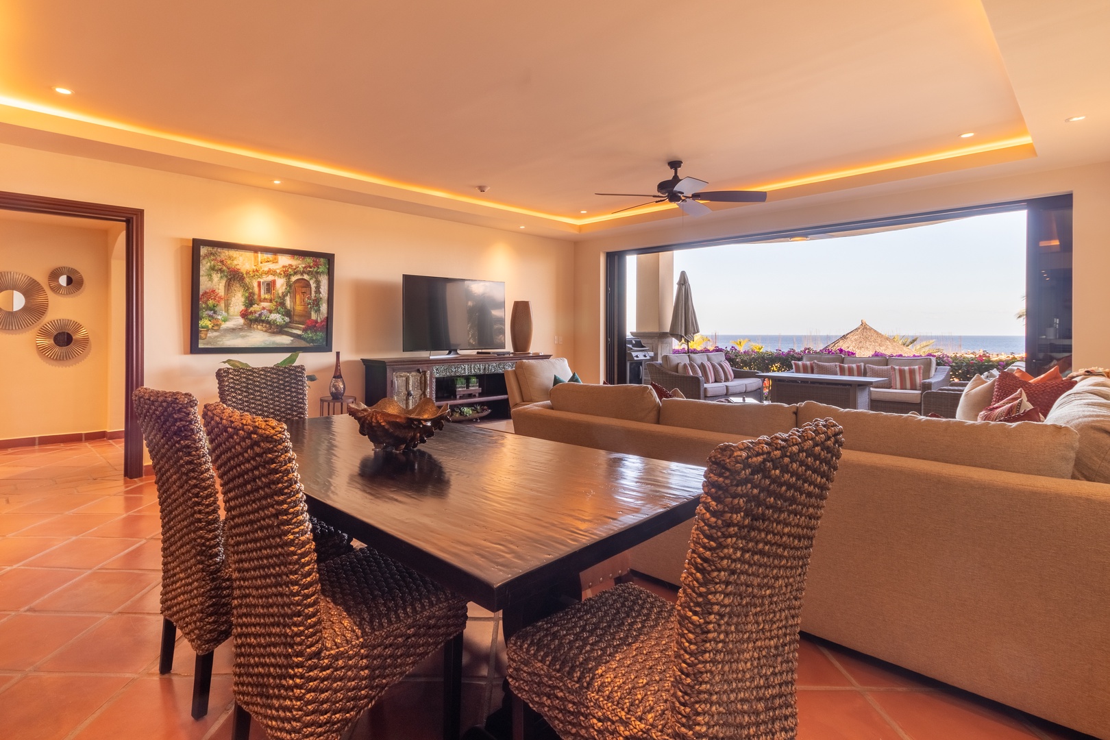 Sink into the plush living area where warm lighting and ocean views create your perfect escape. Step through to your private balcony overlooking stunning coastal landmarks.