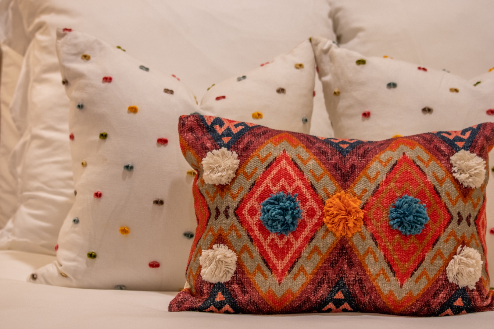 Cozy up with cheerful textured pillows that add a playful pop of color and pattern to your restful retreat.