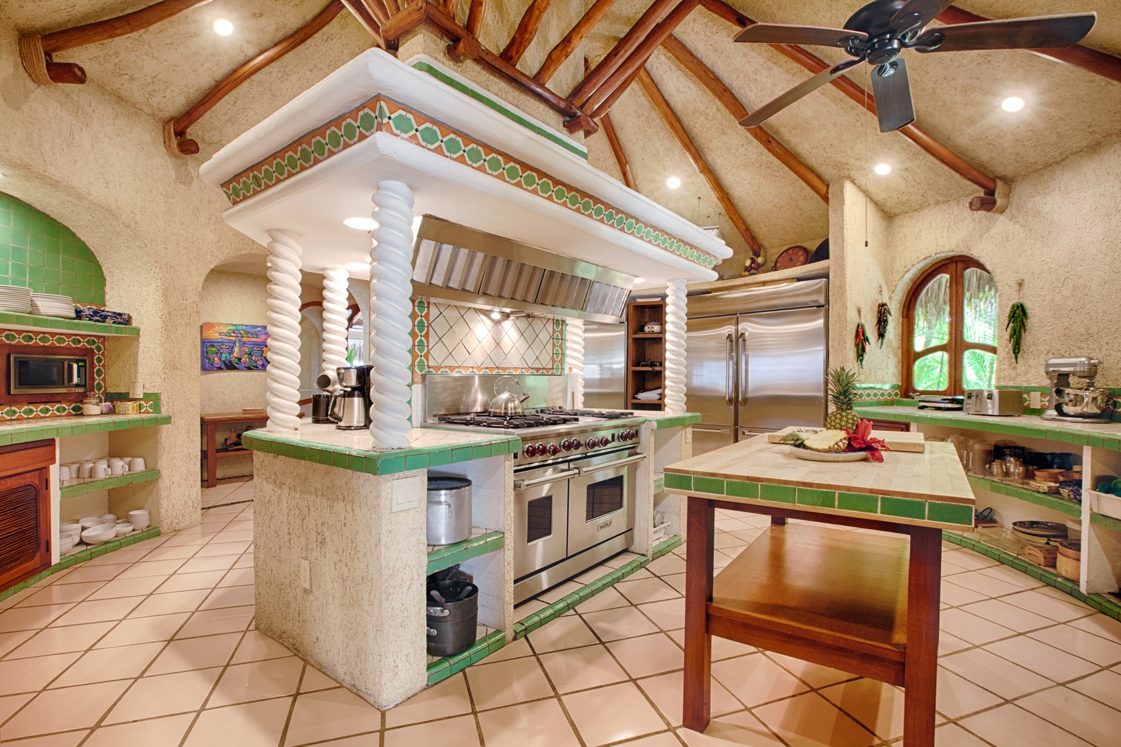 Discover your culinary haven featuring vibrant tiles, exposed beams, and professional appliances perfect for creating memorable meals together.