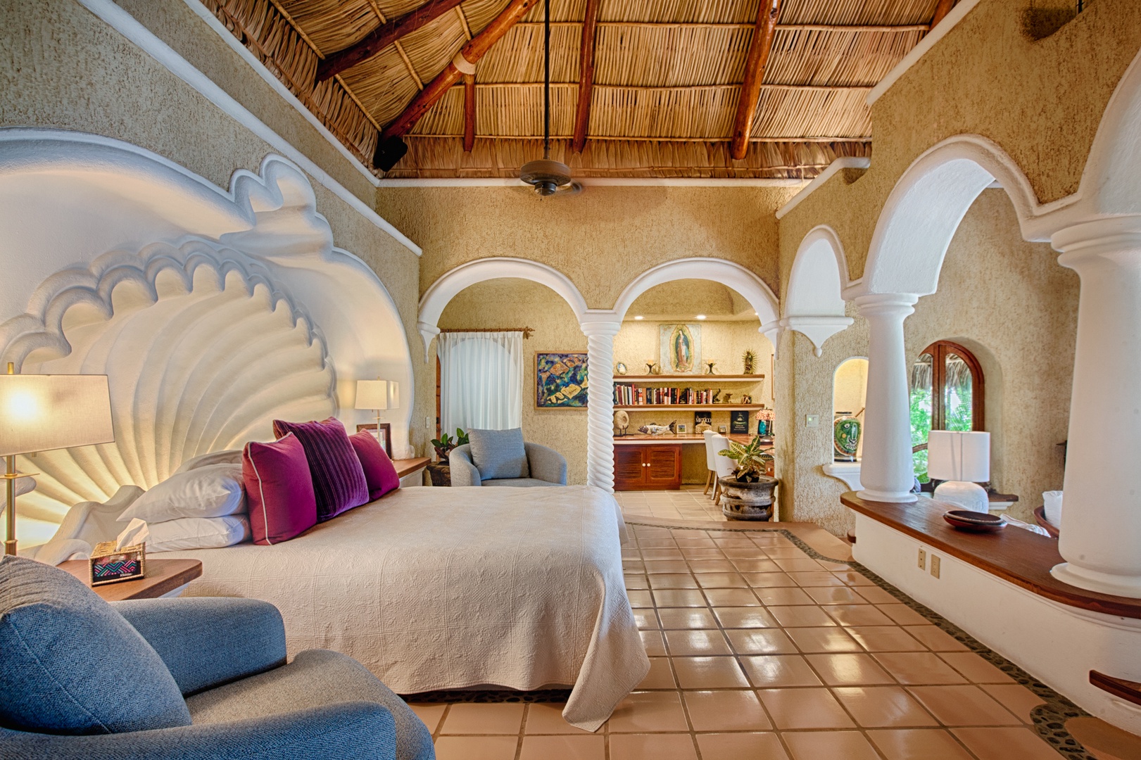 Unwind in your stunning suite with soaring palapa ceiling, elegant arches, and vibrant textiles creating a magical Mexican retreat.