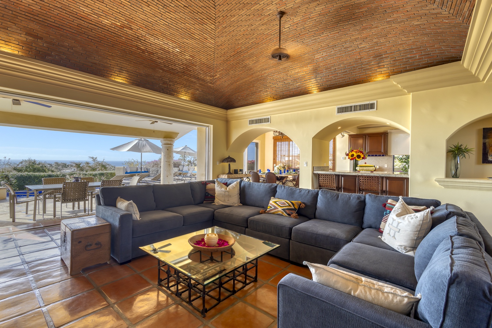 Unwind in your spacious living room with soaring brick ceilings and panoramic views through floor-to-ceiling windows.
