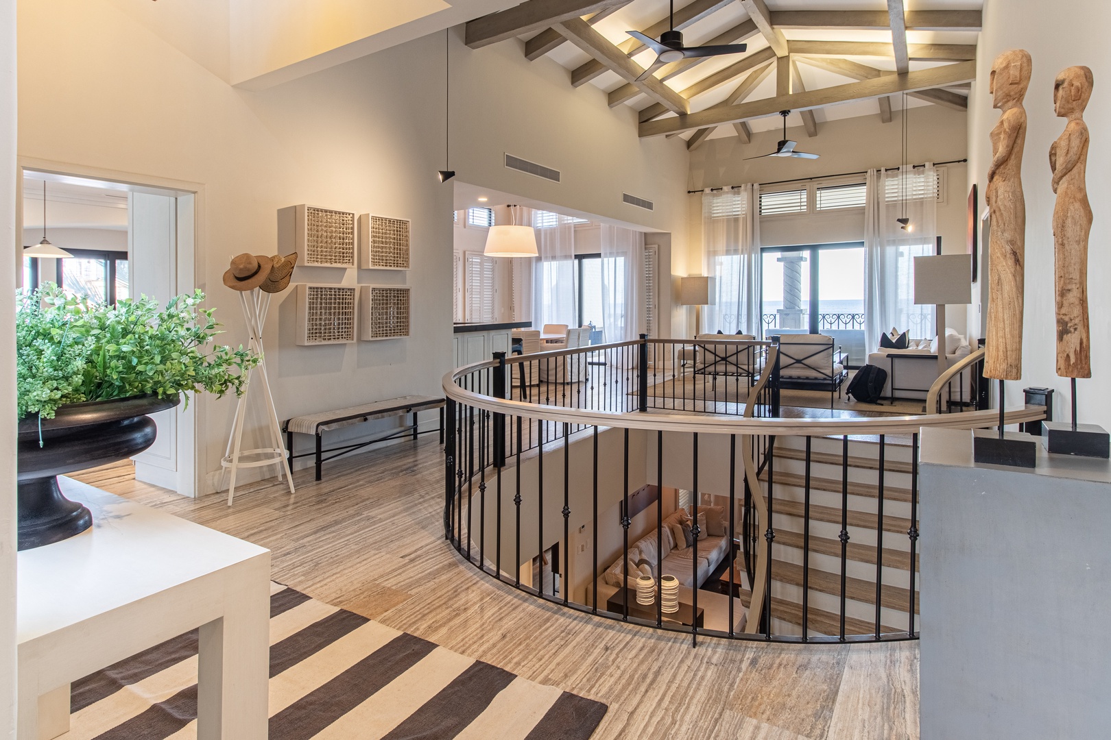 Your vacation begins in this stunning open-concept space, where soaring beamed ceilings and natural light create an airy, welcoming atmosphere to unwind.