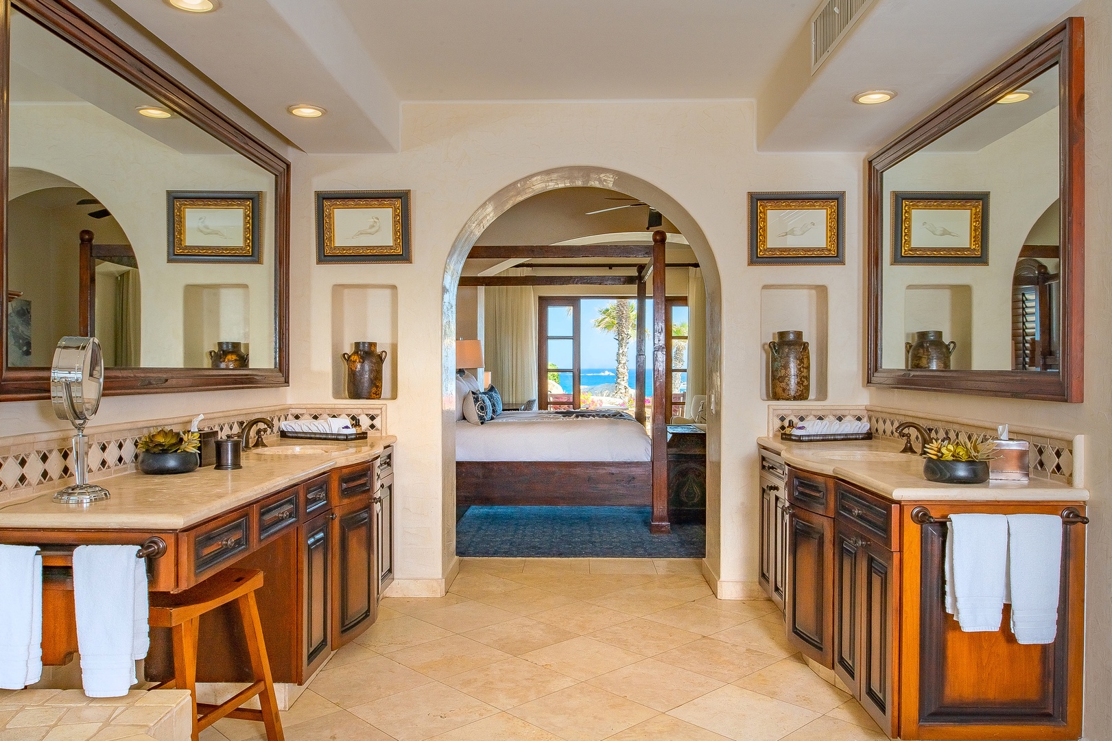Your luxurious dual-vanity bathroom opens to stunning ocean views, where morning routines become pure indulgence.