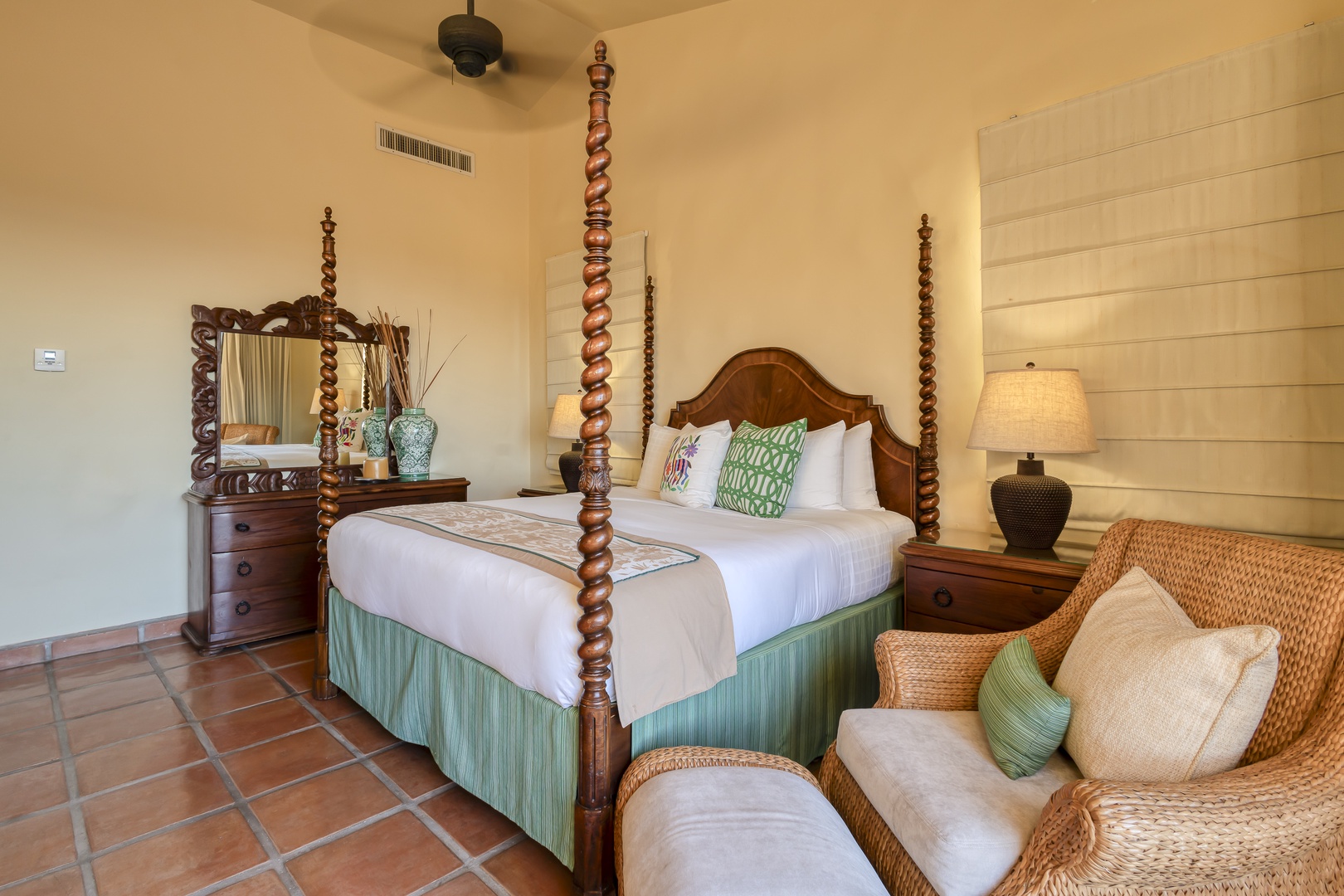 Your charming four-poster bed awaits with crisp linens and tropical touches, while a cozy wicker reading nook invites relaxation.
