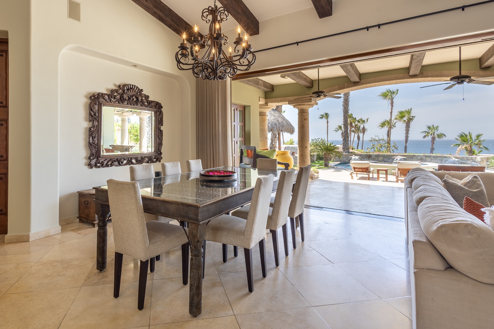 Your elegant dining space flows seamlessly to tropical terraces, where rustic beams meet ocean breezes for unforgettable meals.
