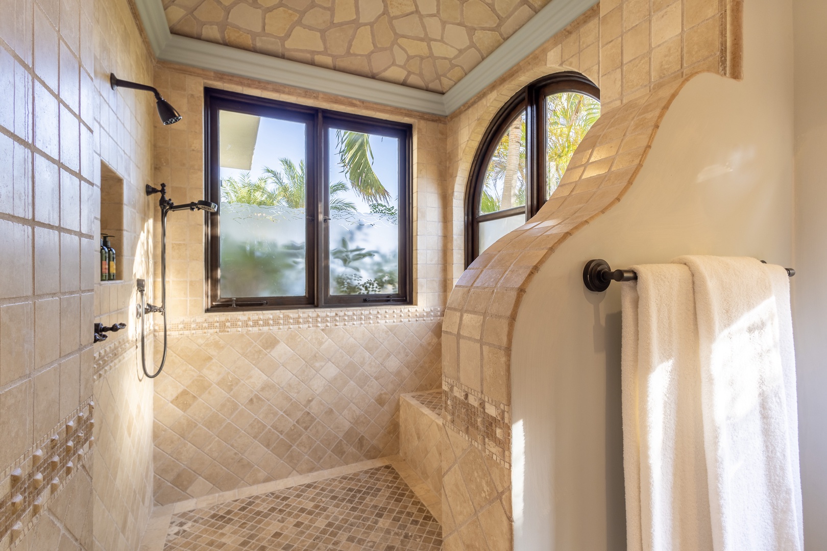 Step into your private spa-like shower with warm tile, natural light, and tropical views framing every moment of your escape.