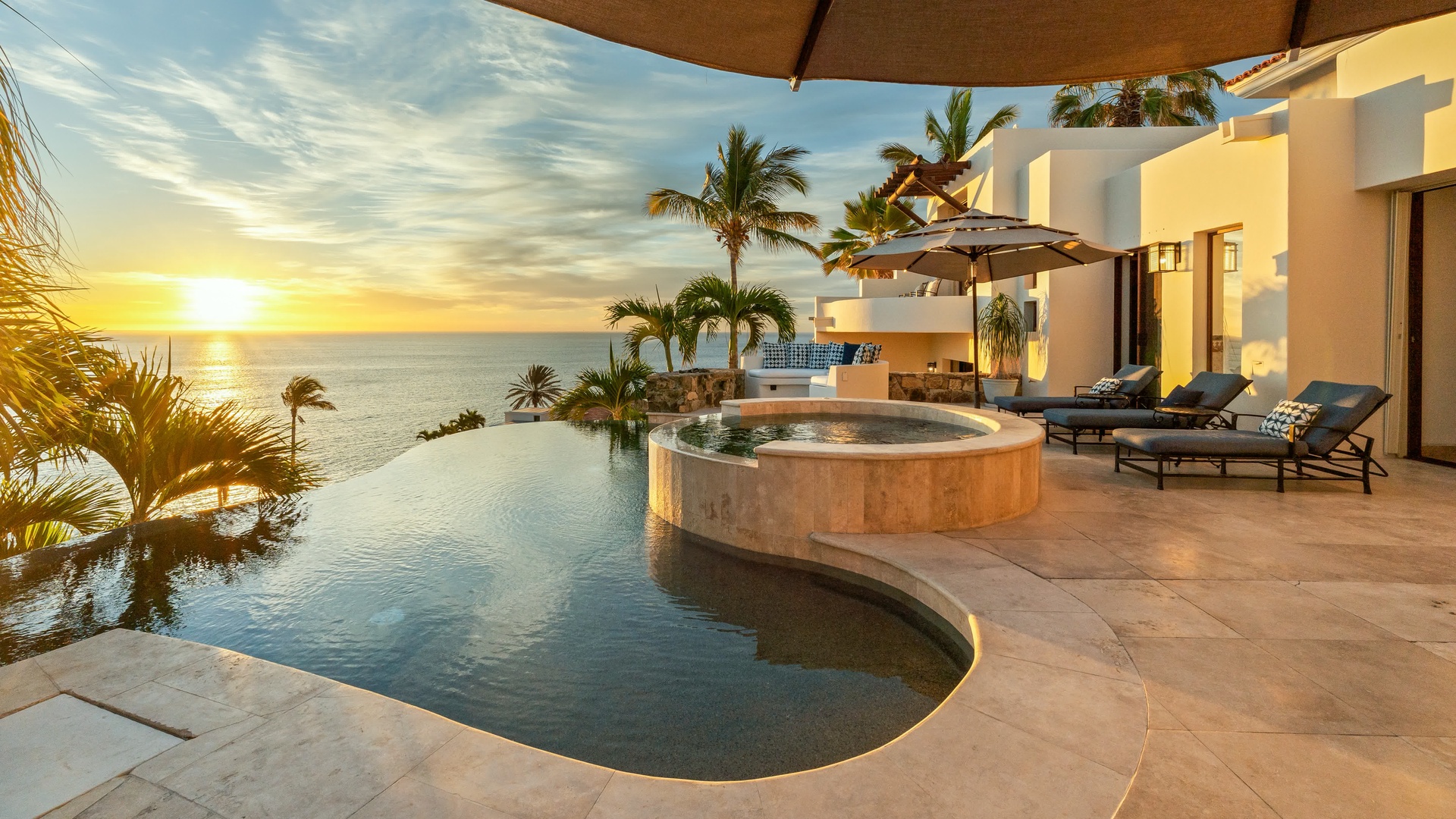 Soak in your private hot tub while watching golden sunsets paint the ocean horizon from your infinity pool terrace.
