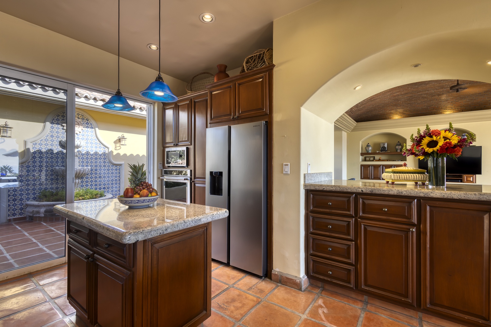 Cook memorable meals in your spacious kitchen featuring granite countertops, stainless steel appliances, and charming archway leading to the living area.