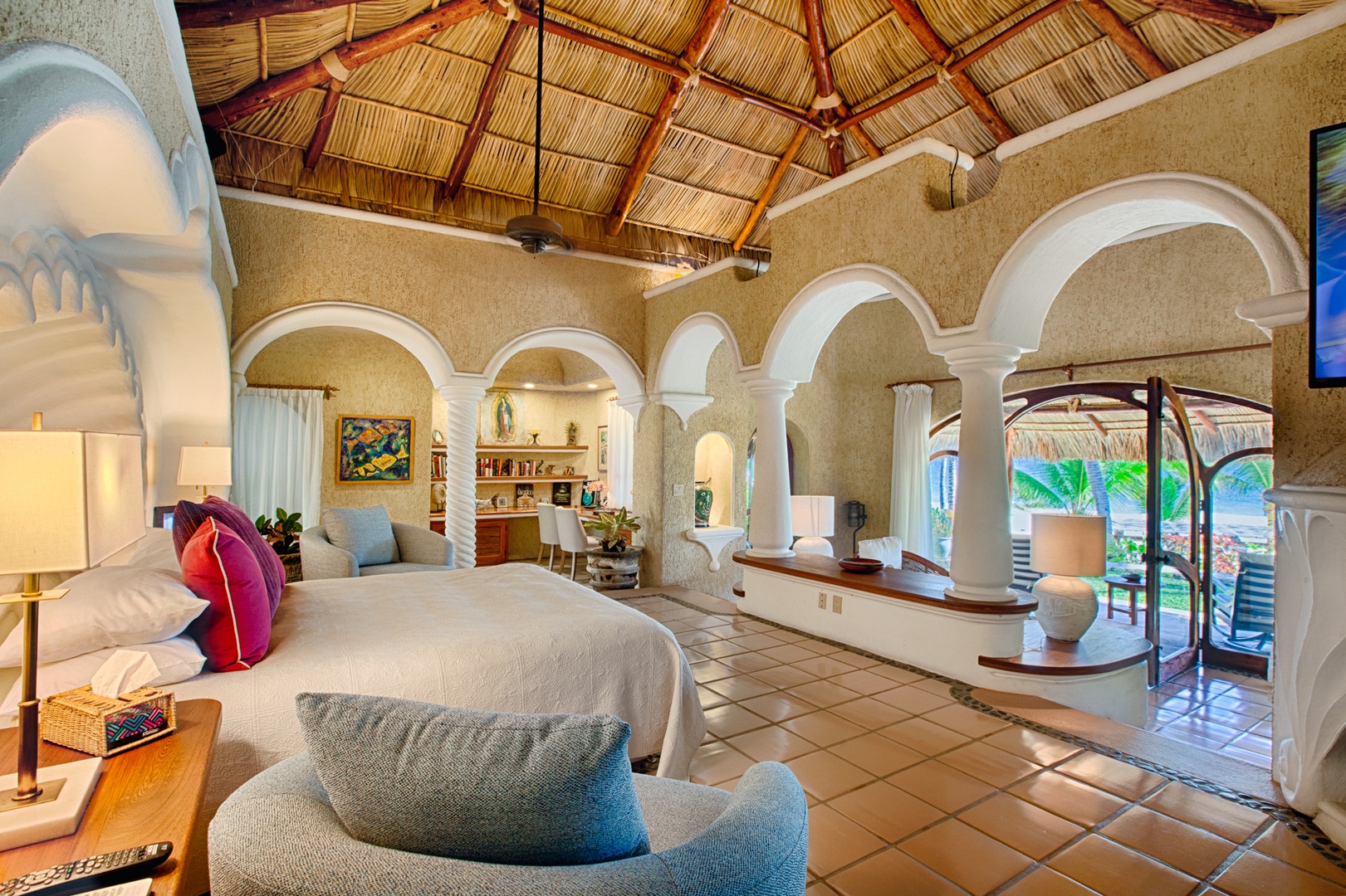 Step into your own tropical paradise with vaulted palapa ceilings, elegant arches, and a dreamy bedroom that opens to lush garden views.