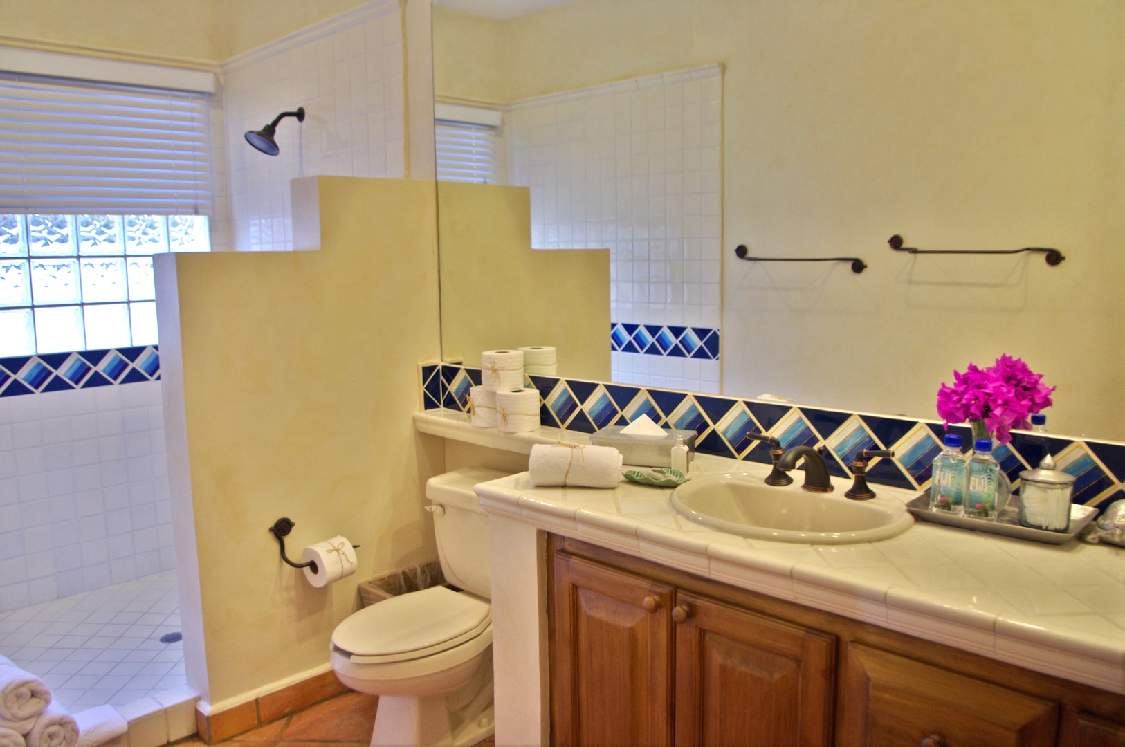 Your private bathroom features hand-painted tile accents, fresh towels, and a walk-in shower—everything you need to refresh after a day of exploring.