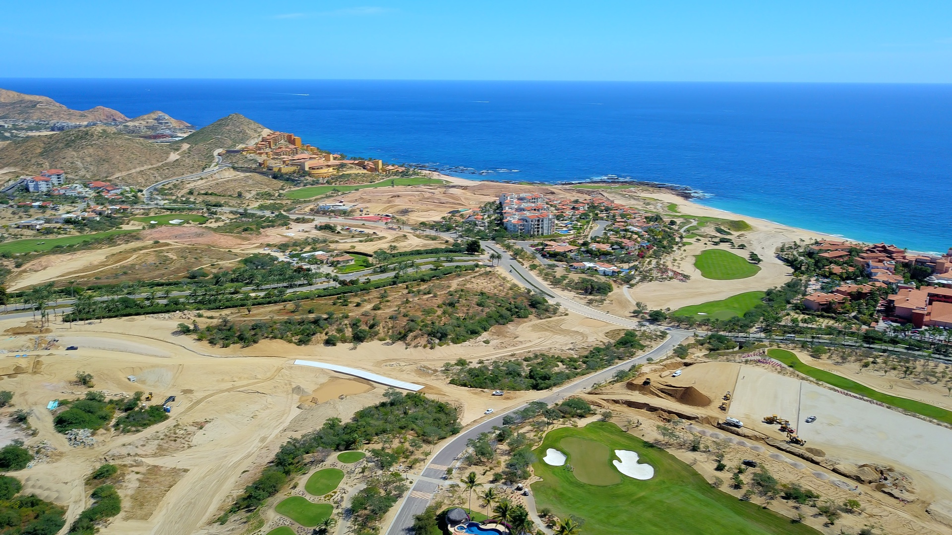 Aerial view of the coastal resort community featuring pristine beaches, championship golf courses, and luxury accommodations along the sparkling blue coastline.