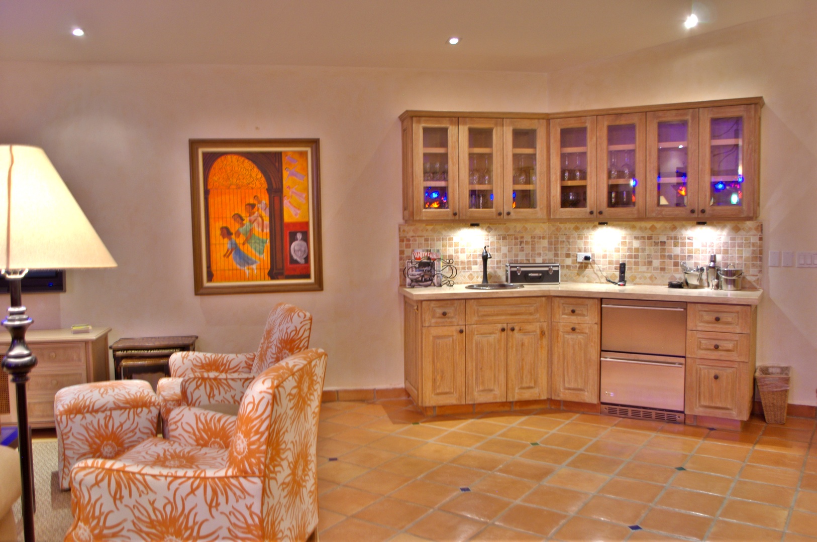 Unwind in your inviting lounge with vibrant artwork, cozy seating, and a stylish kitchenette designed for effortless entertaining and relaxation.