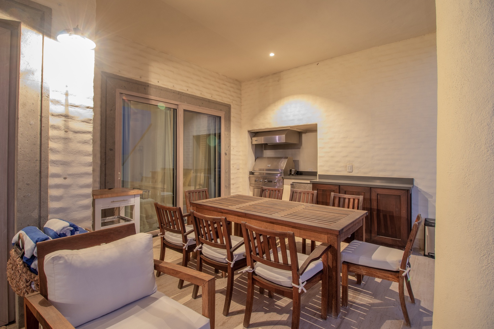 Picture yourself grilling on your own stainless steel BBQ, gathering around this warm wood dining table with friends under soft ambient lighting for an unforgettable evening outdoors.