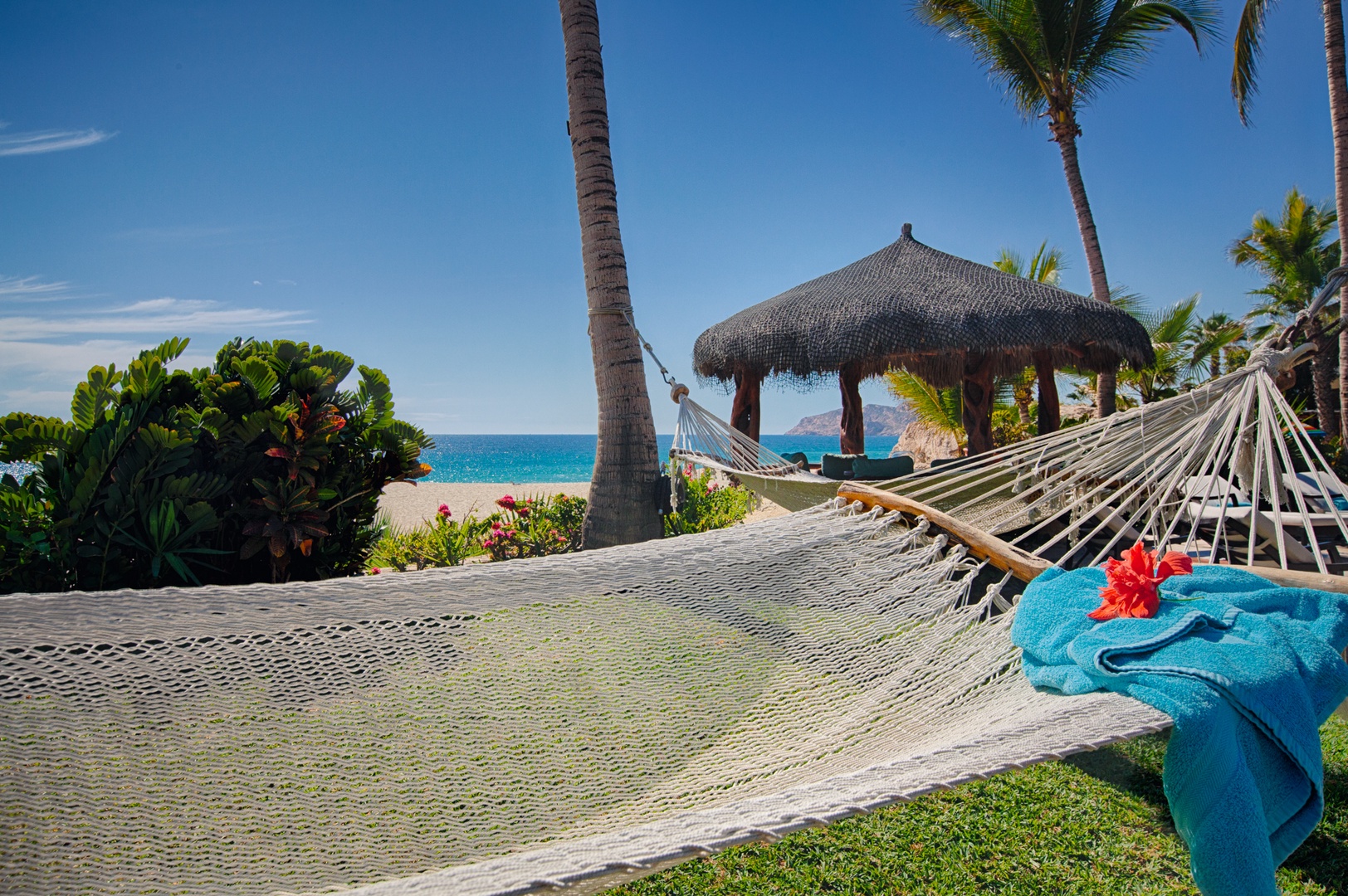 Sink into your private hammock with crystal-clear waters and swaying palms just steps away—pure tropical bliss awaits.