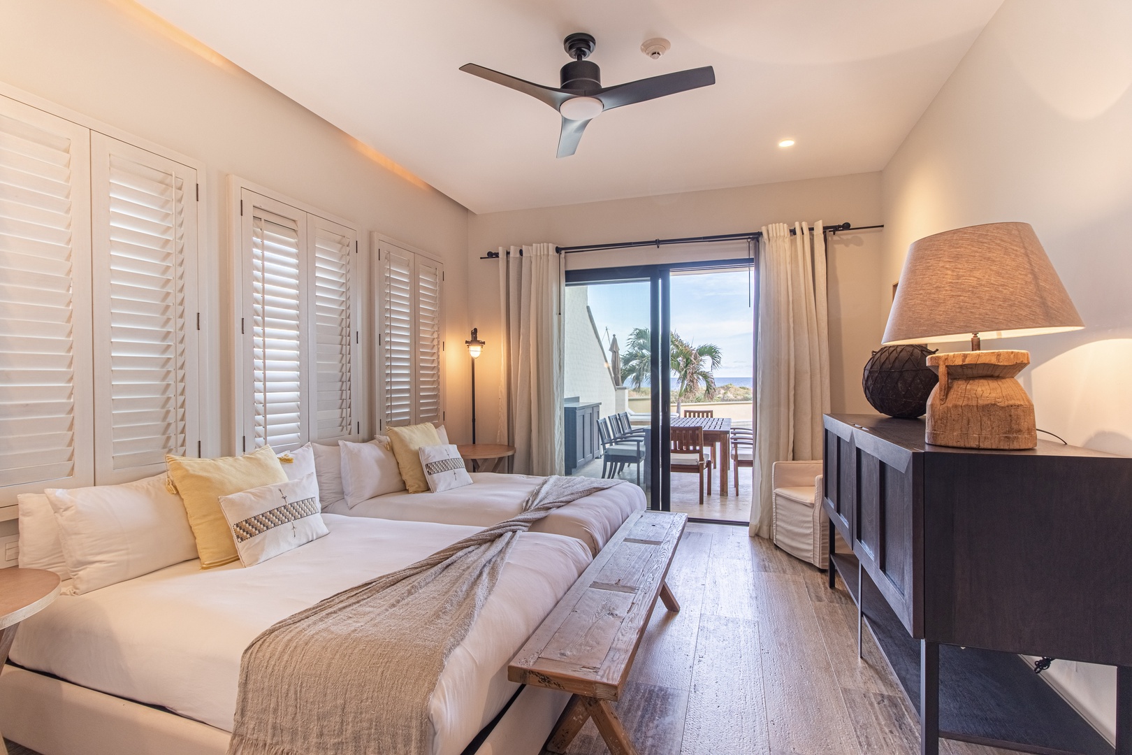 Sink into plush beds with coastal breezes flowing through, and step onto your private balcony to savor palm-lined views and the soothing rhythm of the sea.