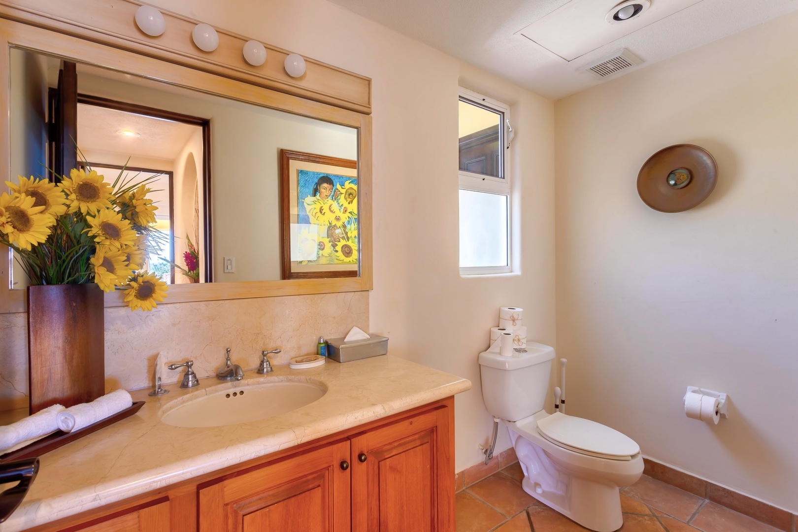 Freshen up in your bright bathroom with cheerful sunflowers, custom vanity, and natural light streaming through the window.
