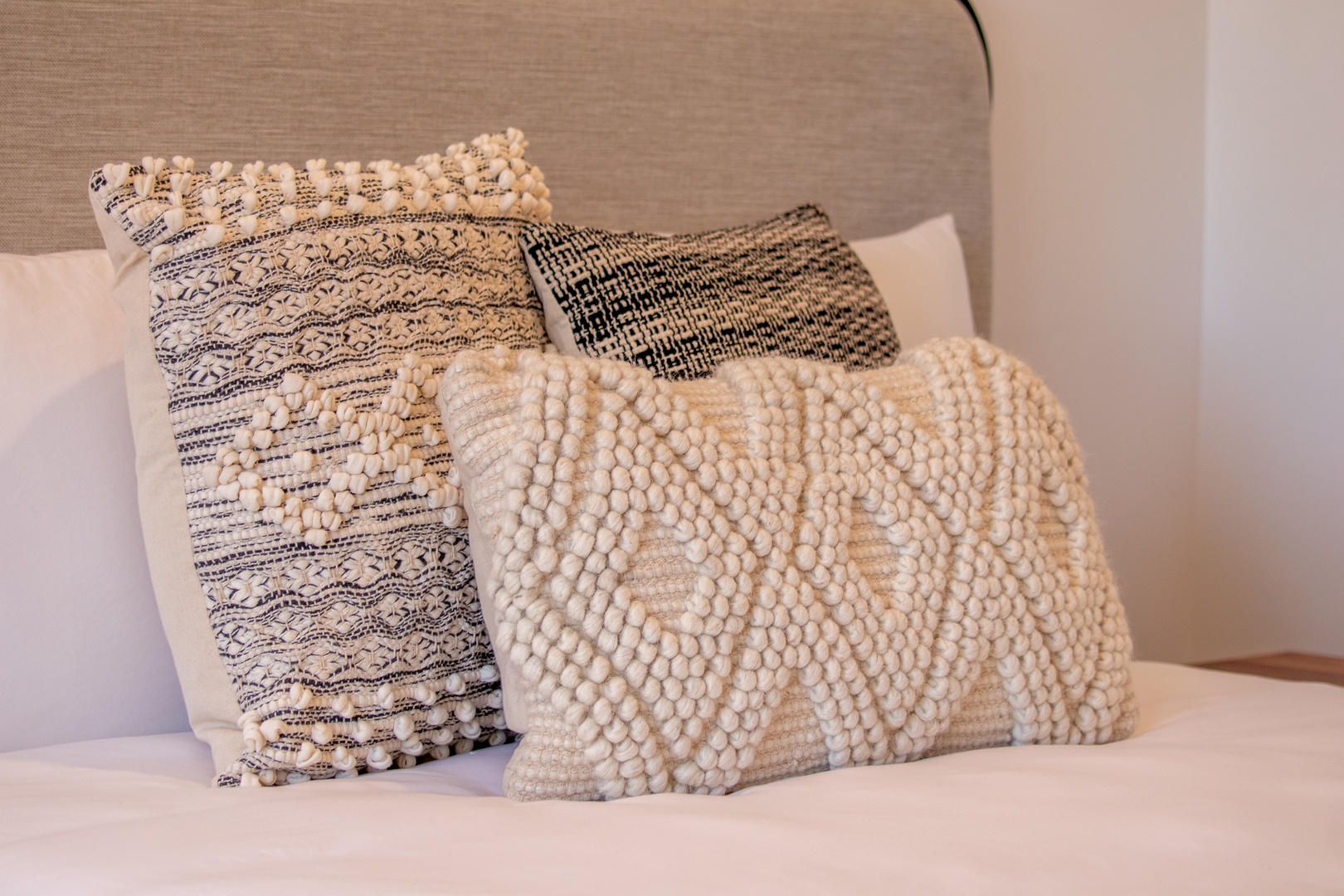 Sink into plush comfort with these beautifully textured pillows, designed to make your stay feel like home. The layered patterns and soft tones invite you to relax.