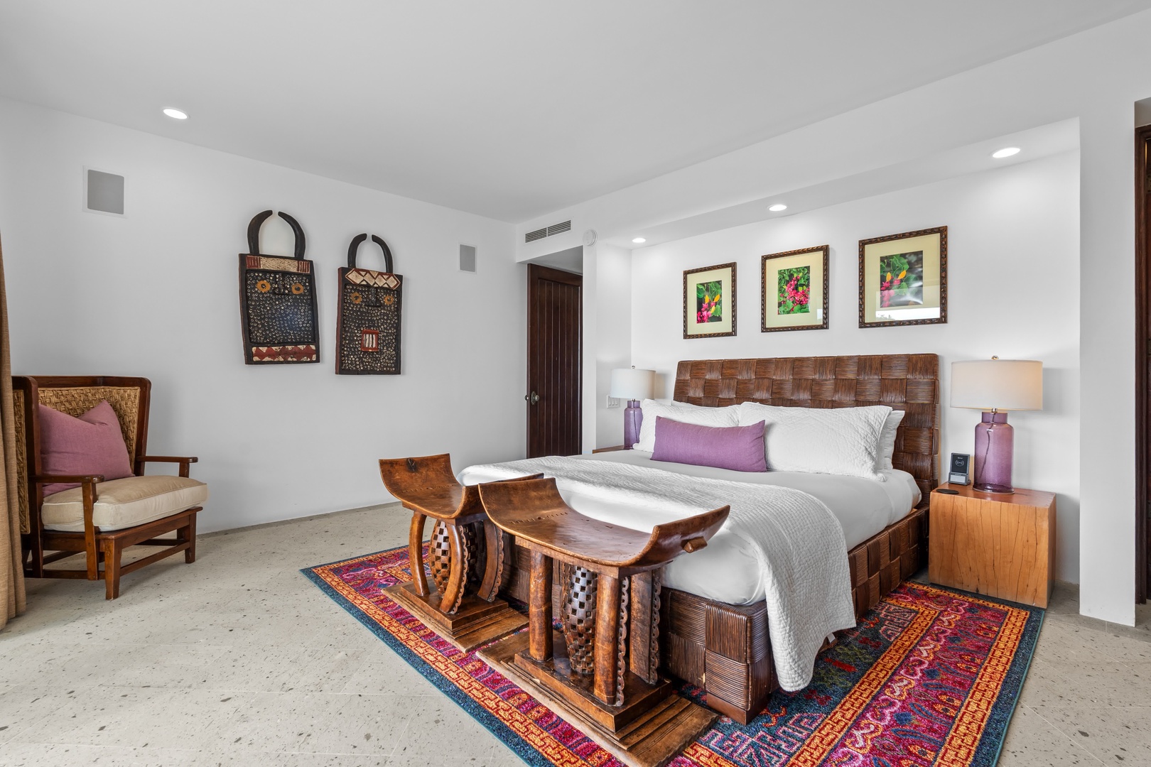 Retreat to your elegant bedroom featuring rich wood furnishings, authentic local artwork, and plush bedding for the perfect night's rest.