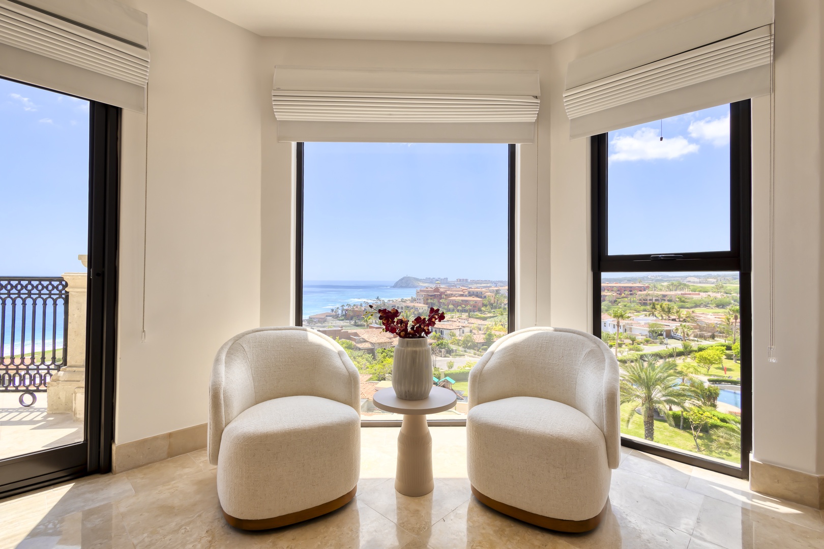Sink into plush seating and let your gaze drift across the sparkling coastline—your peaceful retreat with breathtaking ocean and island views awaits.