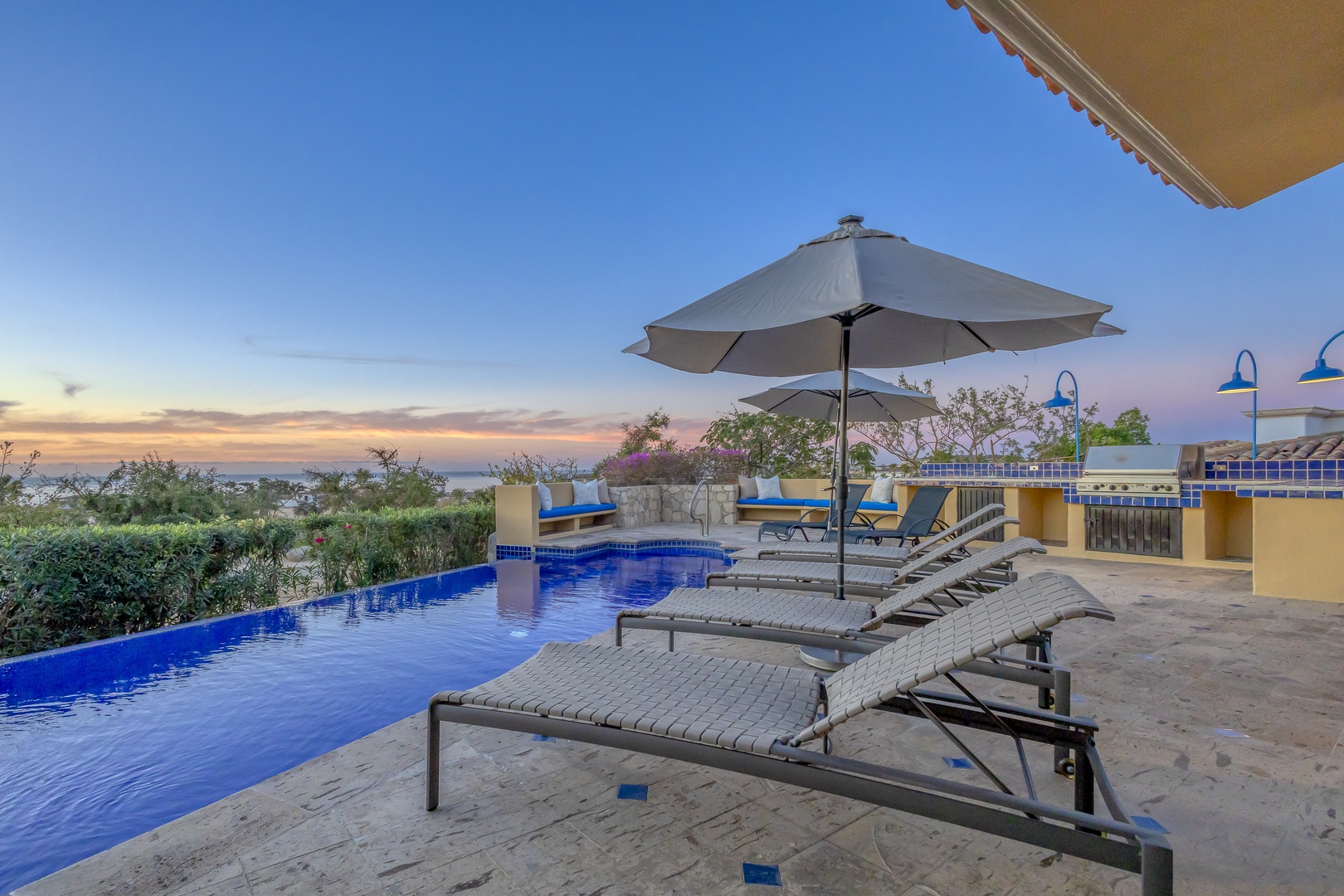 Stunning infinity pool with loungers awaits your sunset relaxation, offering breathtaking views and the perfect spot to unwind after exploring.