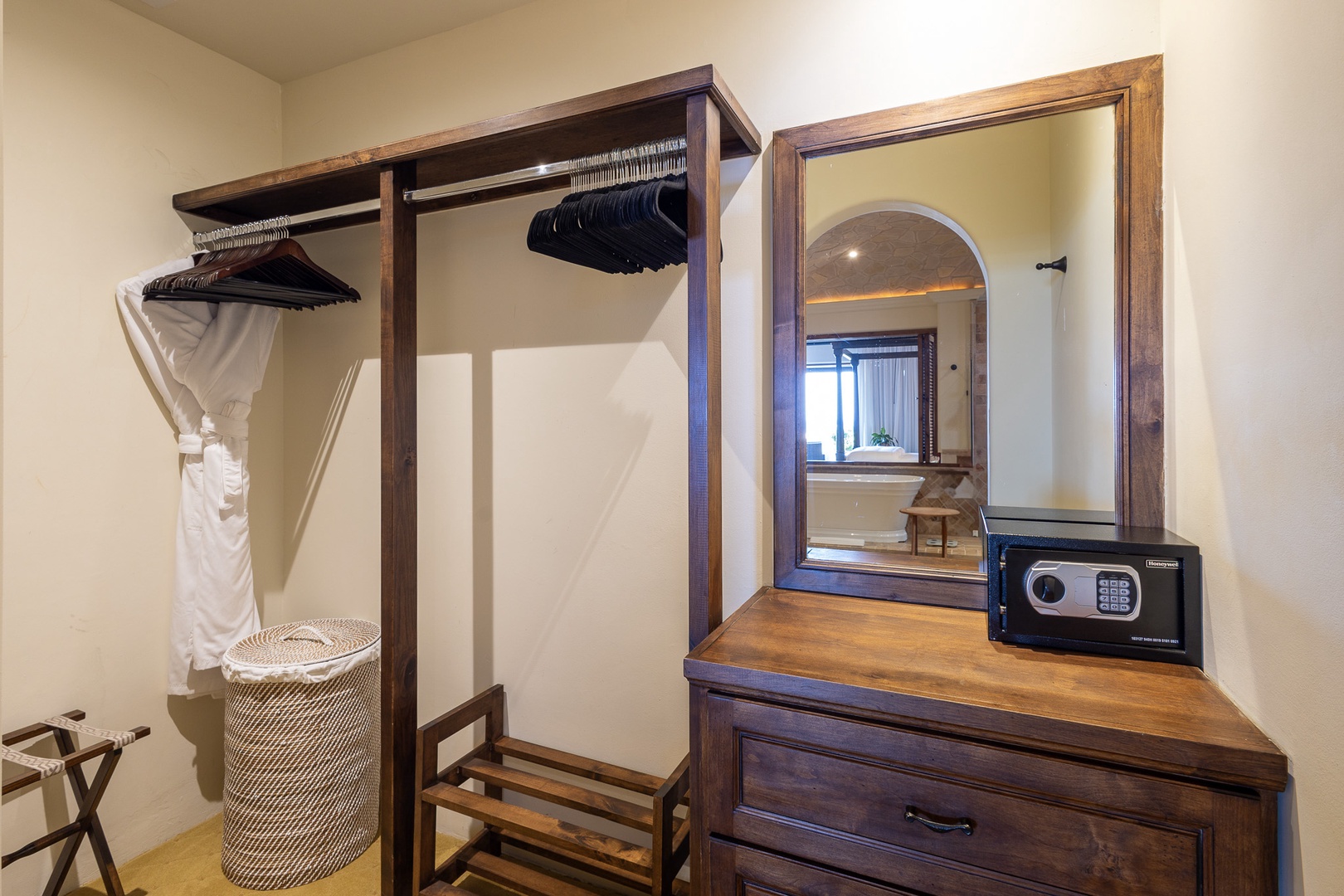 Your wardrobe features plush robes and hangers for unpacking, while a dresser with mirror and electronic safe keeps your belongings secure and organized throughout your stay.