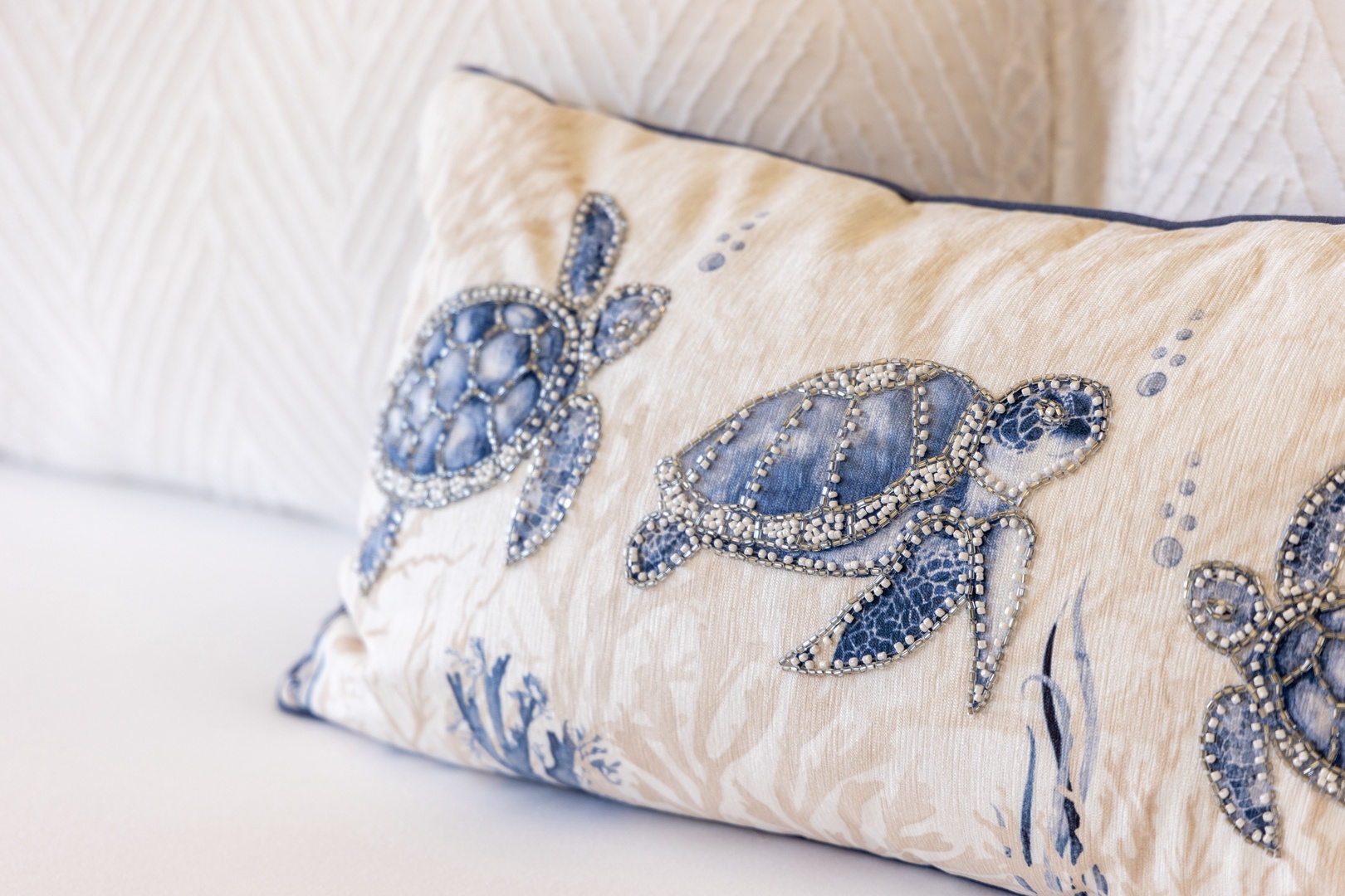 Unwind against soft linens adorned with shimmering sea turtle details, bringing a touch of coastal charm to your bedtime retreat.