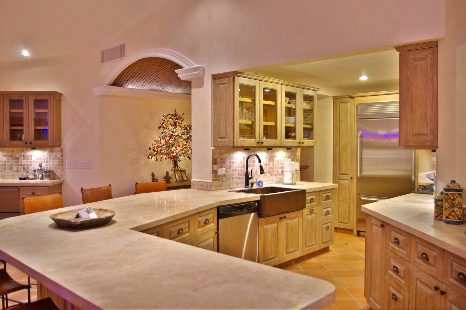 Gather in this beautifully appointed gourmet kitchen where your culinary adventures begin. Warm wood cabinetry, gleaming countertops, and top-tier appliances create a chef's paradise for your vacation meals.