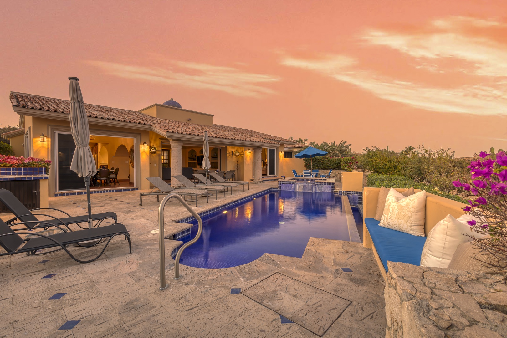 Stunning villa with private pool and dramatic sunset backdrop creates an unforgettable desert retreat experience.