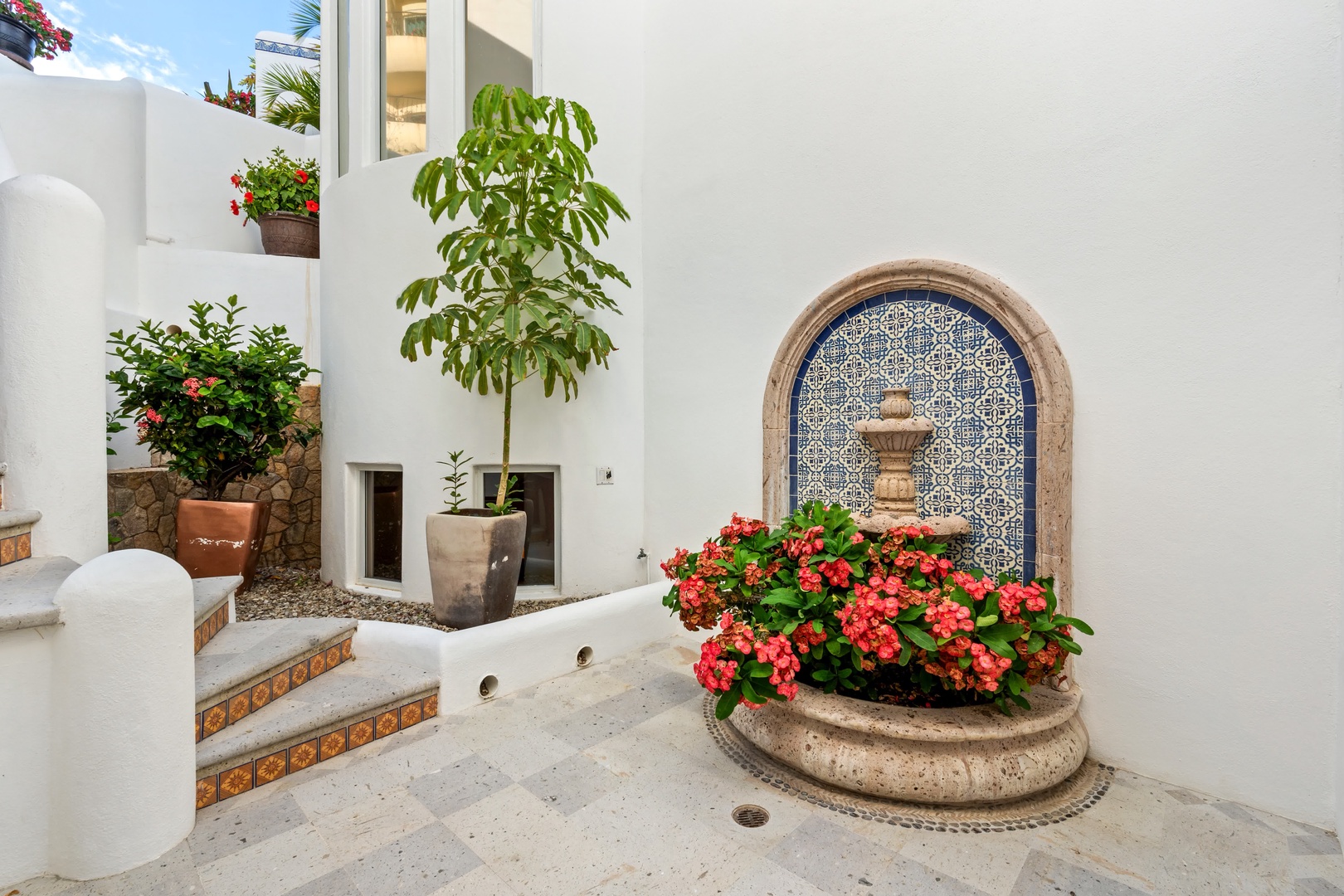 You'll discover tranquil Mediterranean charm in this private courtyard, where colorful blooms and flowing fountains create your perfect retreat.
