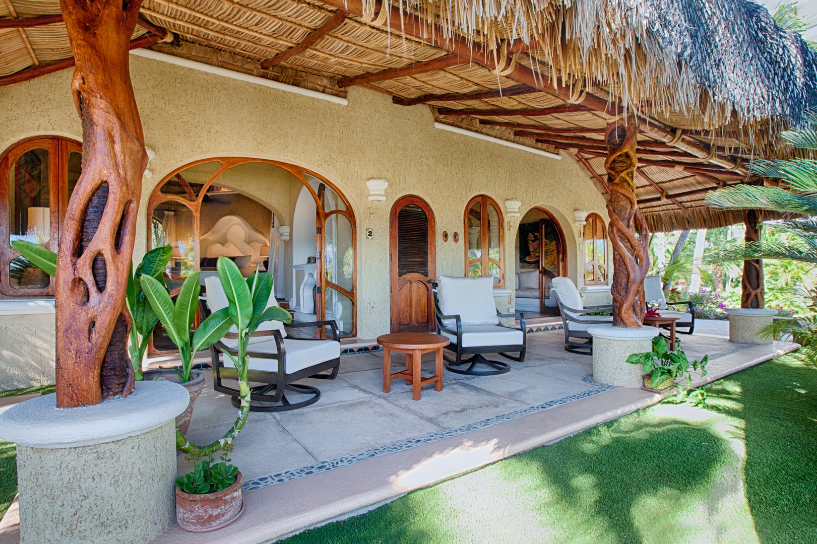 Relax on your private covered terrace with tropical styling, comfortable seating, and lush garden views creating your perfect outdoor sanctuary.