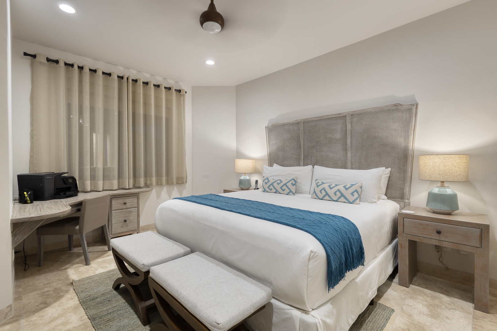 Sink into crisp white linens and soft accent pillows after a day of exploring. Your coastal-inspired bedroom features bedside lamps, workspace nook, and peaceful neutral tones for restful nights.