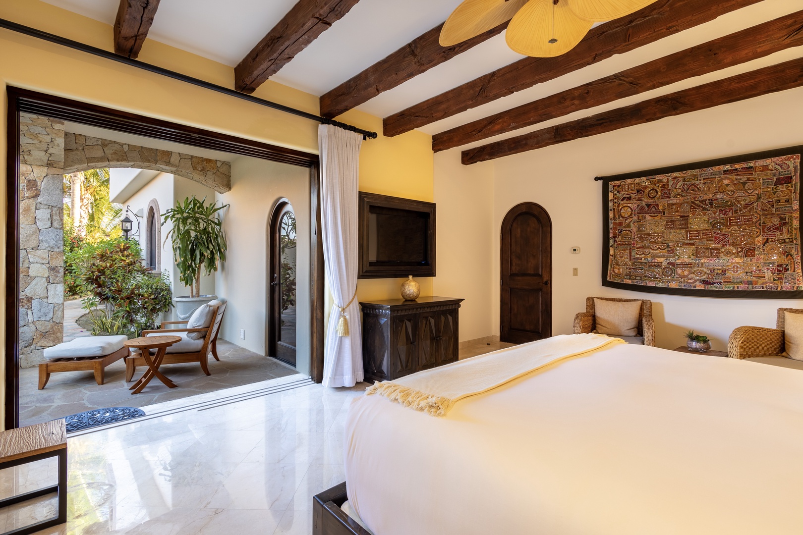 Wake up in this serene suite where rustic beams and warm textures blend with modern comfort. Your private terrace invites you to unwind with morning coffee surrounded by greenery.
