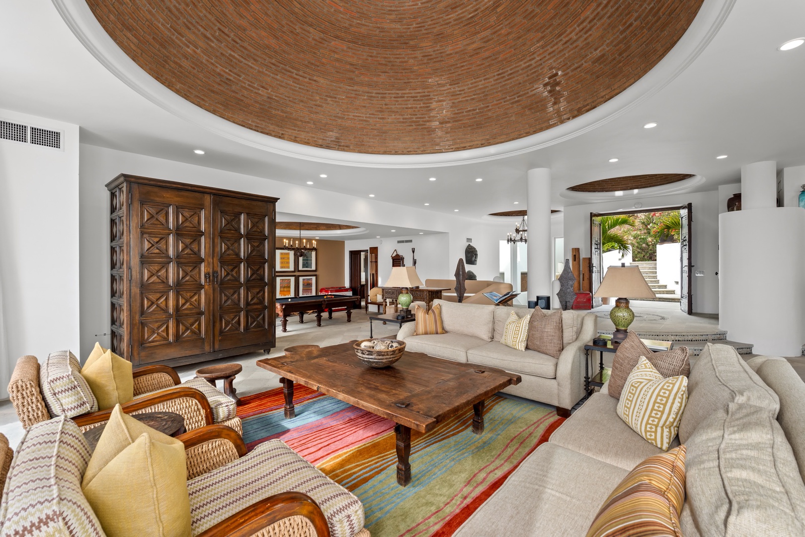 Relax in your stunning living space featuring soaring ceilings, plush sectional seating, and elegant furnishings that create the perfect atmosphere for memorable gatherings.