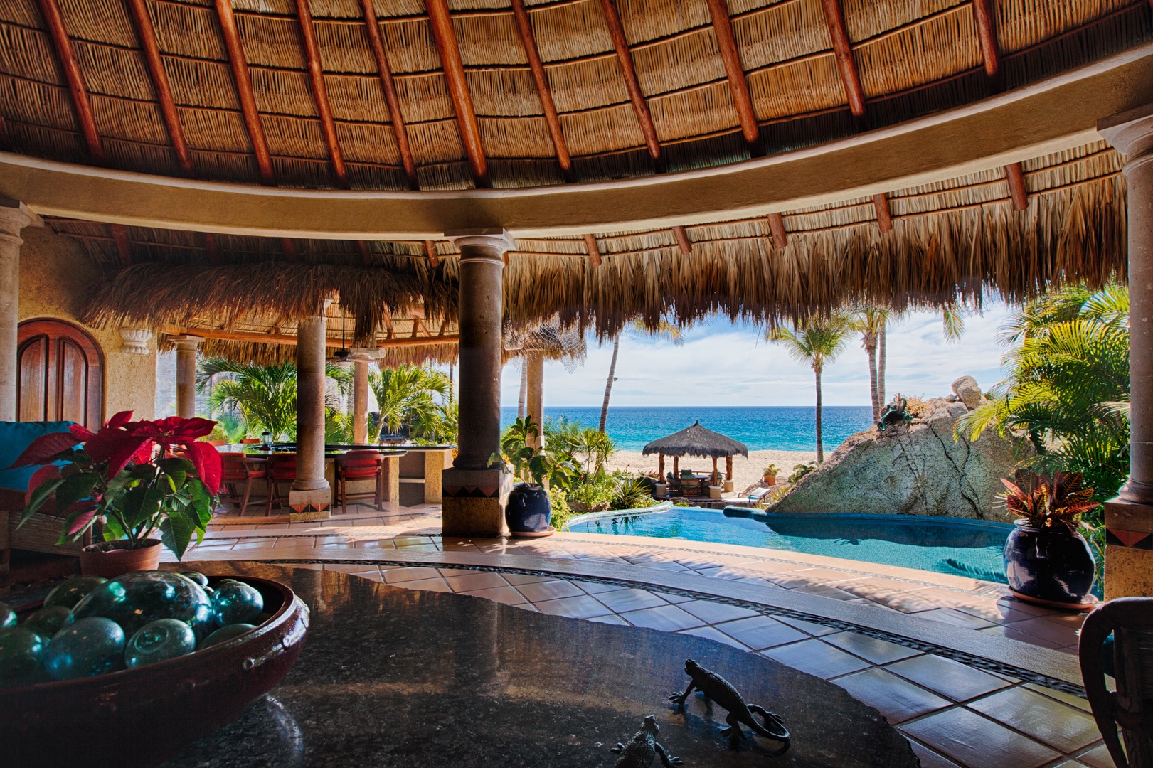 Your tropical paradise awaits with stunning ocean views from this luxurious palapa-style living space, where infinity pool meets pristine beach.
