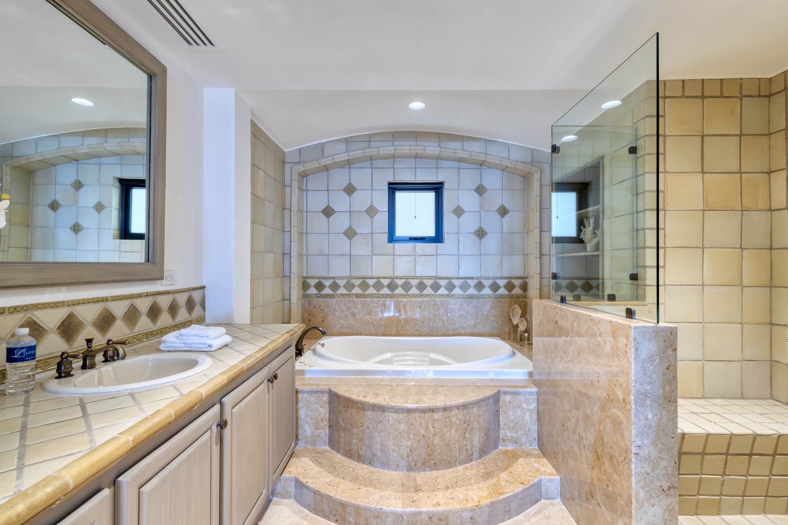 Indulge in your private spa retreat with a luxurious soaking tub, spacious walk-in shower, and elegant tile details that create a tranquil haven for ultimate relaxation.