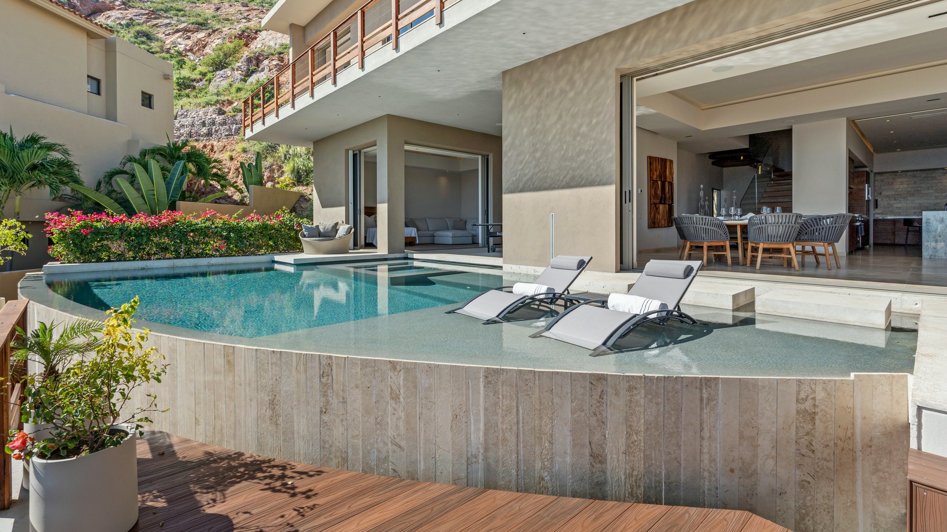 Relax by your private pool on sleek sunbeds, surrounded by lush gardens and contemporary architecture that blends indoor and outdoor living seamlessly.