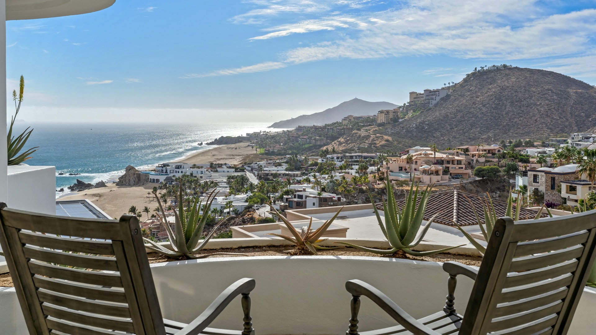 Panoramic coastal views stretch across sandy beaches and hillside resort communities from this elevated terrace vantage point.